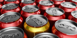 Yellow soda can standing out amongst red soda cans