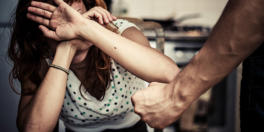 Woman Covering Her Face In Fear Of Domestic Violence